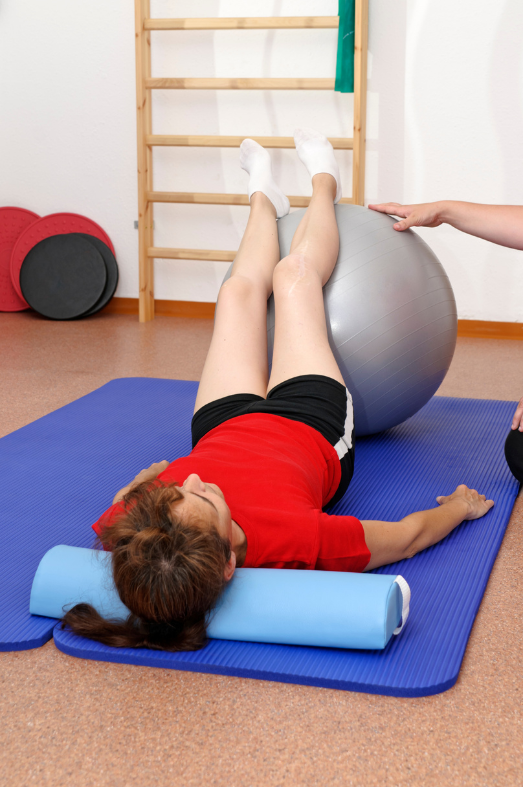 A woman being given exercise advice from a women's health physiotherapist for pelvic floor physiotherapy.