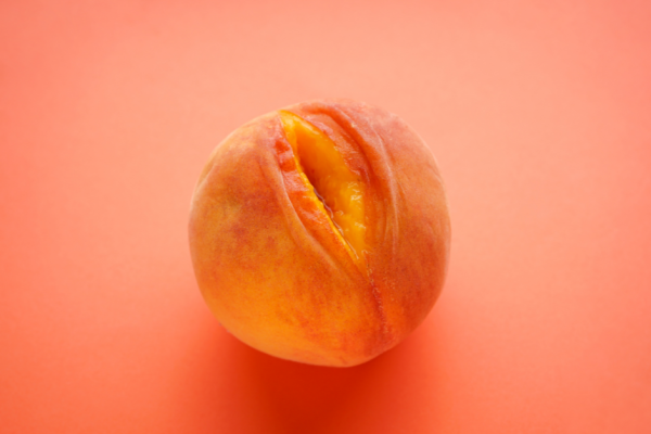 Peach with an opening resembling a woman's vagina.